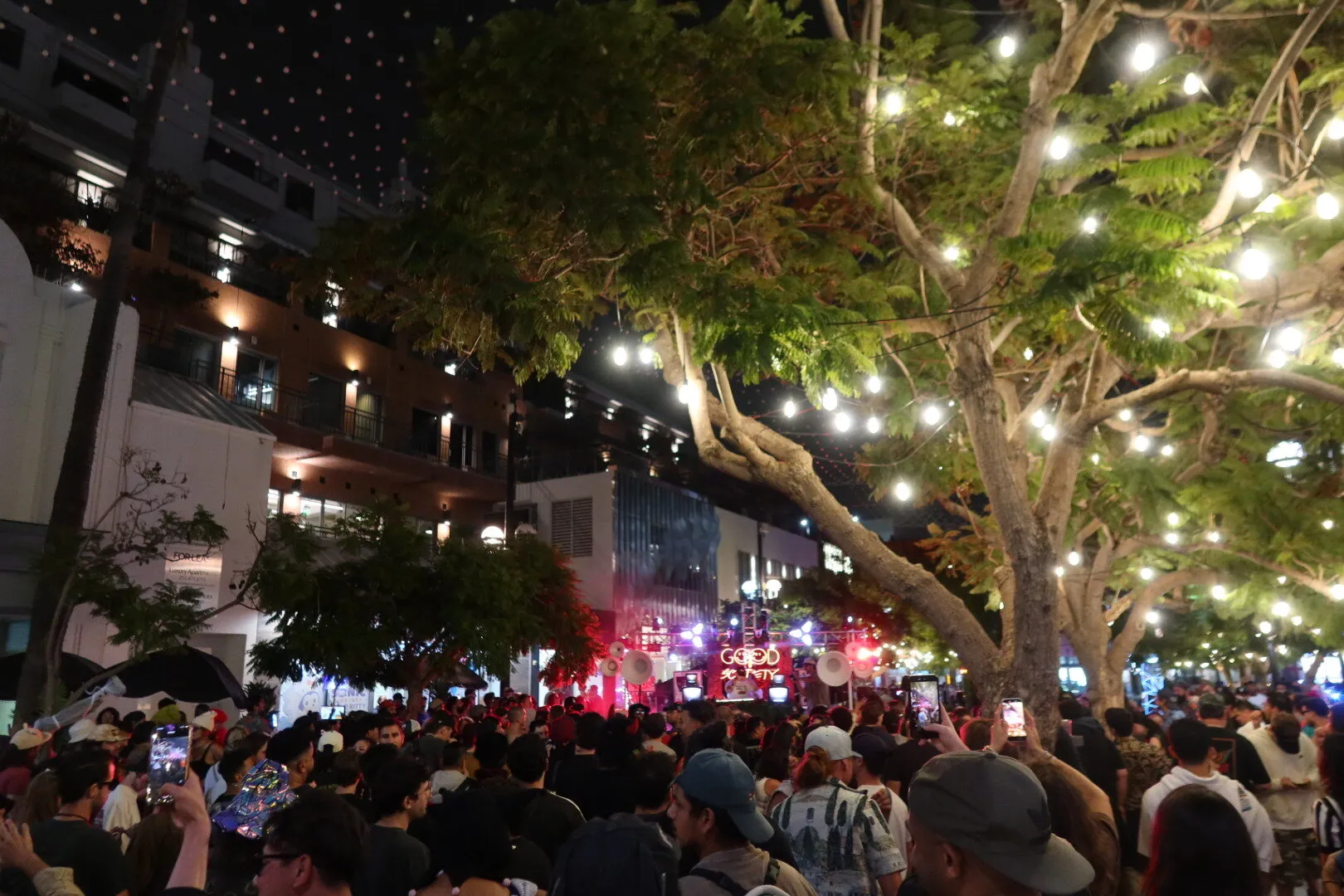 Crowd filling Third Street Promenade under string lights in front of the Good Society stage